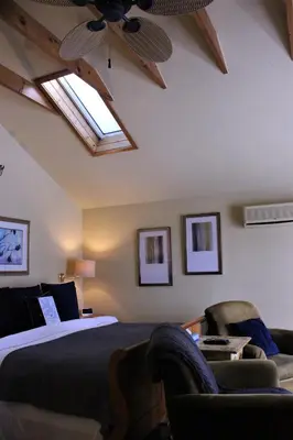 a bedroom with a bed and a ceiling with skylights at The Breadalbane Inn in Fergus
