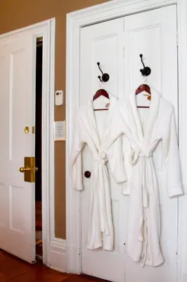 two white coats on hangers on a door at The Breadalbane Inn in Fergus