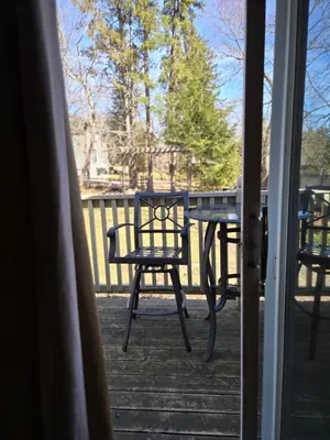 a patio table and chair on a porch at The Breadalbane Inn in Fergus