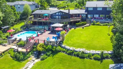 an aerial view of a house with a swimming pool at Lux Lakeside Escape Slps 20 with Pool, Golf Sim, Hot Tub, Karaoke, Gym and Sauna in Peterborough