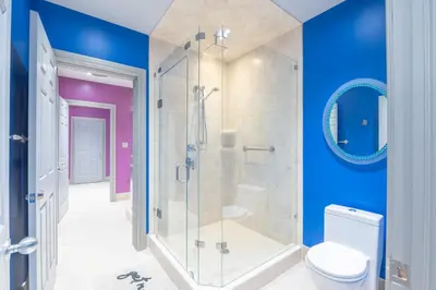 a bathroom with a glass shower and a toilet at Lux Lakeside Escape Slps 20 with Pool, Golf Sim, Hot Tub, Karaoke, Gym and Sauna in Peterborough