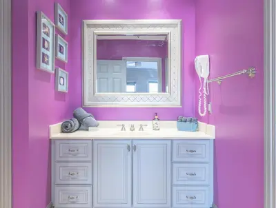 a bathroom with a sink and a mirror at Lux Lakeside Escape Slps 20 with Pool, Golf Sim, Hot Tub, Karaoke, Gym and Sauna in Peterborough