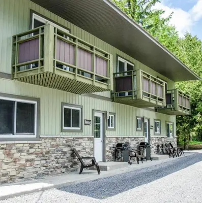 a building with benches and balconies on it at Westlake Cottage - Hillier Lodge in Wellington