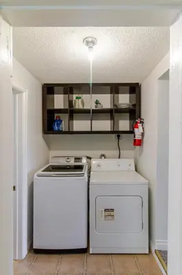 a kitchen with two washes and a washer and dryer at Westlake Cottages - Highway House in Wellington