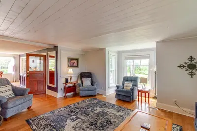 a living room with two chairs and a table at Westlake Cottages - Highway House in Wellington
