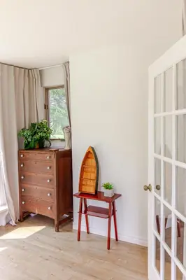 a room with a dresser and a table and a mirror at Westlake Cottages - Highway House in Wellington