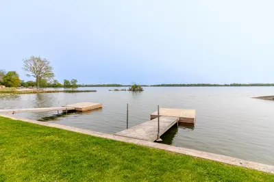a dock in the middle of a lake at Westlake Cottage - Milford Lodge in Wellington