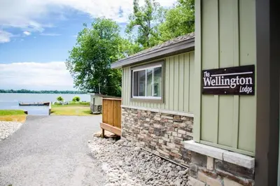 a building with a sign on the side of it at Westlake Cottage - Wellington Lodge in Wellington