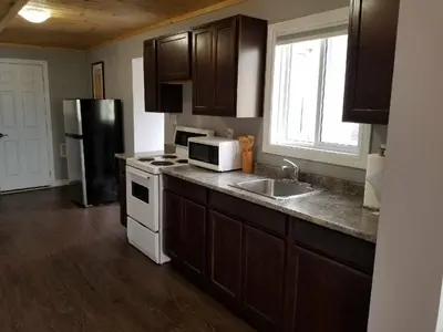 a kitchen with a sink and a microwave at Westlake Cottage - Wellington Lodge in Wellington
