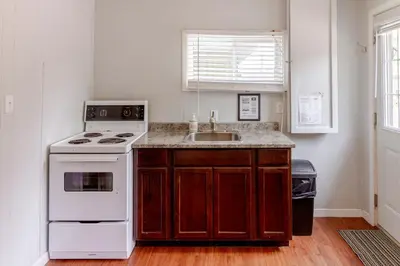 a kitchen with a white stove and a sink at Westlake Cherry Valley Cottage in Wellington