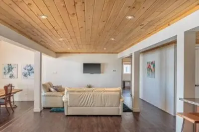 a living room with a couch and a table at Westlake Consecon Cottage in Wellington