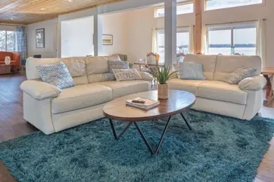 a living room with a couch and a table at Westlake Consecon Cottage in Wellington