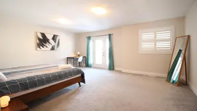a bedroom with a bed and a window at Beautiful House Near Grand River & Kiwanis Park in Kitchener