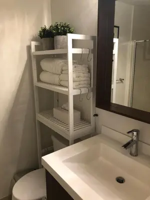 a bathroom with a sink and a toilet and towels at Chic Toronto Blue Jays Getaway in Toronto