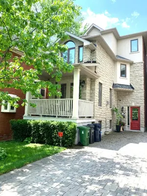 a house with a porch and a driveway at Luxury Home - Upper Toronto Beaches in Toronto