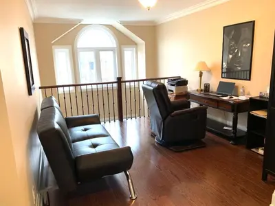 a living room with two chairs and a desk at Luxury Home - Upper Toronto Beaches in Toronto