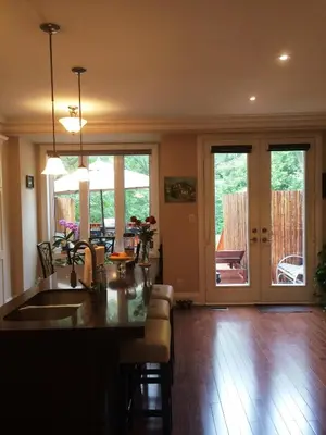 a kitchen and living room with a table and chairs at Luxury Home - Upper Toronto Beaches in Toronto