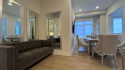 a living room with a couch and a dining room at French Style Mansion In Prestigious Angus Glen Markham in Markham