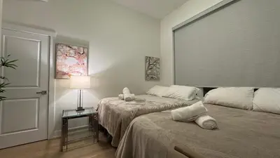 a bedroom with two beds and a lamp on a table at French Style Mansion In Prestigious Angus Glen Markham in Markham