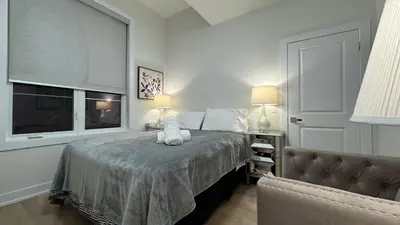 a bedroom with a bed with white pillows and a window at French Style Mansion In Prestigious Angus Glen Markham in Markham