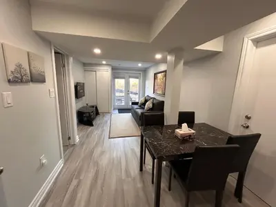 a living room with a table and a couch at Whitby Hideout - 3BR, 5BD, 3WR, Pool Table, Sauna in Whitby