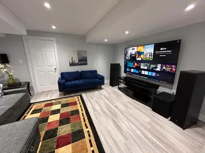 a living room with a large flat screen tv at Whitby Hideout - 3BR, 5BD, 3WR, Pool Table, Sauna in Whitby