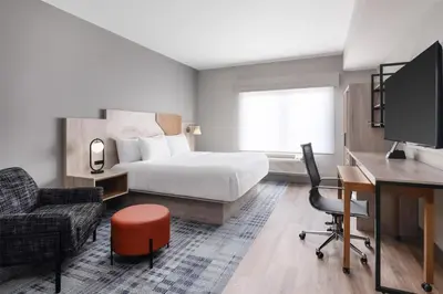 a hotel room with a bed and a desk and a computer at @HOME by Best Western Walkerton in Walkerton