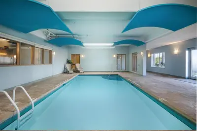 a large swimming pool with a blue ceiling at @HOME by Best Western Walkerton in Walkerton