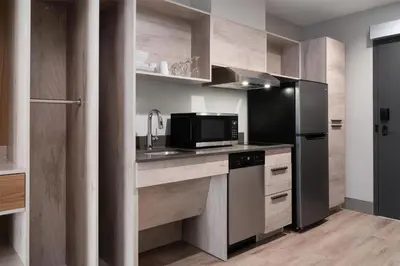 a kitchen with a sink and a refrigerator at @HOME by Best Western Walkerton in Walkerton