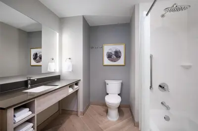 a bathroom with a toilet and a sink and a shower at @HOME by Best Western Walkerton in Walkerton