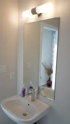 a bathroom with a white sink and a mirror at Newly Built 3 plus 1 bedroom Ravine lot Townhouse, Brampton, Ontario in Brampton