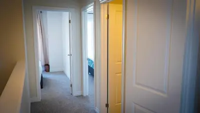 a hallway with two white doors and a yellow door at Newly Built 3 plus 1 bedroom Ravine lot Townhouse, Brampton, Ontario in Brampton