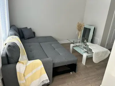a living room with a couch and a table at Newly Built 3 plus 1 bedroom Ravine lot Townhouse, Brampton, Ontario in Brampton
