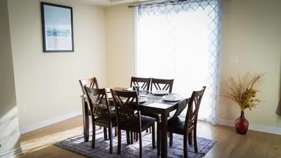 a dining room with a table and chairs at Newly Built 3 plus 1 bedroom Ravine lot Townhouse, Brampton, Ontario in Brampton