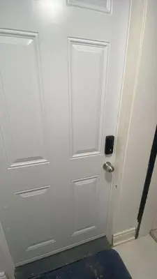 a white door in a room with a blue rug at 2 bedroom 2 bath separate basement unit in Cambridge