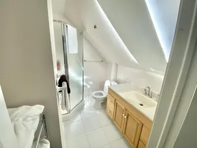 a white bathroom with a sink and a toilet at Cozy 1 bedroom 4 mins to falls in Niagara Falls