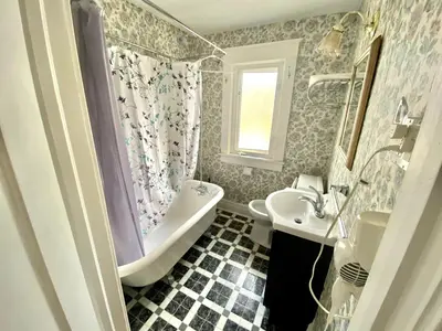 a bathroom with a white tub and a sink at Two bedrooms unit with jacuzzi in Niagara Falls