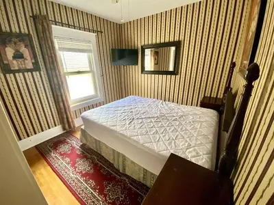 a bedroom with a bed in a room with a window at Two bedrooms unit with jacuzzi in Niagara Falls