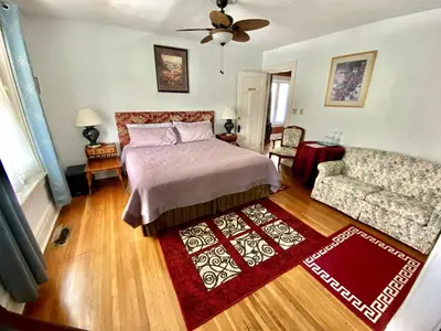 a bedroom with a bed and a couch at Entire guest suite in the Falls in Niagara Falls