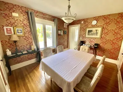 a dining room with a white table and chairs at Entire guest suite in the Falls in Niagara Falls