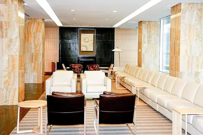 a waiting room with a large couch and chairs at Exquisite Living Toronto in Toronto