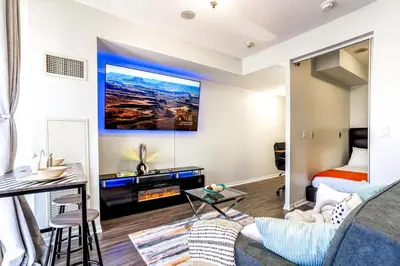 a living room with a bed and a couch at Exquisite Living Toronto in Toronto