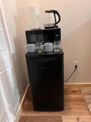 a coffee maker on top of a black refrigerator at Smokehouse Suites and Stay in Guelph