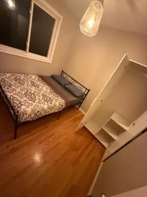 a small bedroom with a bed and a window at STAY AT FLAT CAD 39- Next to Airport, Transit, Park in Kitchener
