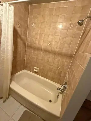 a white bath tub in a bathroom with a shower at STAY AT FLAT CAD 39- Next to Airport, Transit, Park in Kitchener