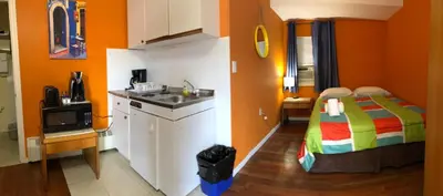 a kitchen with a bed and a sink in a room at Wasaga Motel Inn in Wasaga Beach
