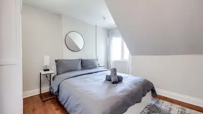 a bedroom with a bed with a teddy bear on it at Urban Oasis, 3-Bedroom Apartment at Prime Location in Toronto