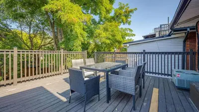 a patio with a table and chairs on a deck at Urban Oasis, 3-Bedroom Apartment at Prime Location in Toronto