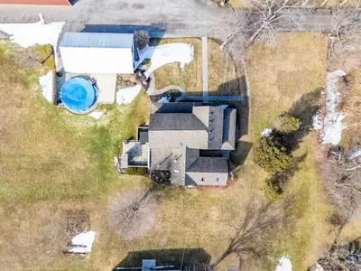 an overhead view of a house with a pool at Vintage 8BR Farmhouse With Hot Tub Spacious Yard in Port Colborne