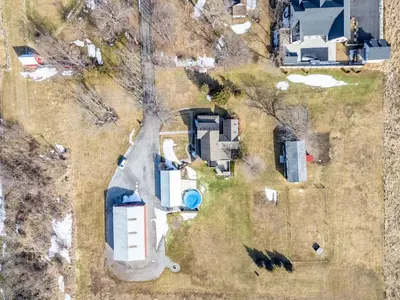 an overhead view of a yard with a house at Vintage 8BR Farmhouse With Hot Tub Spacious Yard in Port Colborne